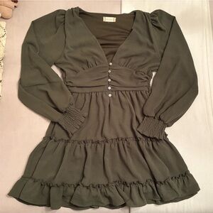green deep v neck altar’d state mini dress with a cinched waist and tiered skirt